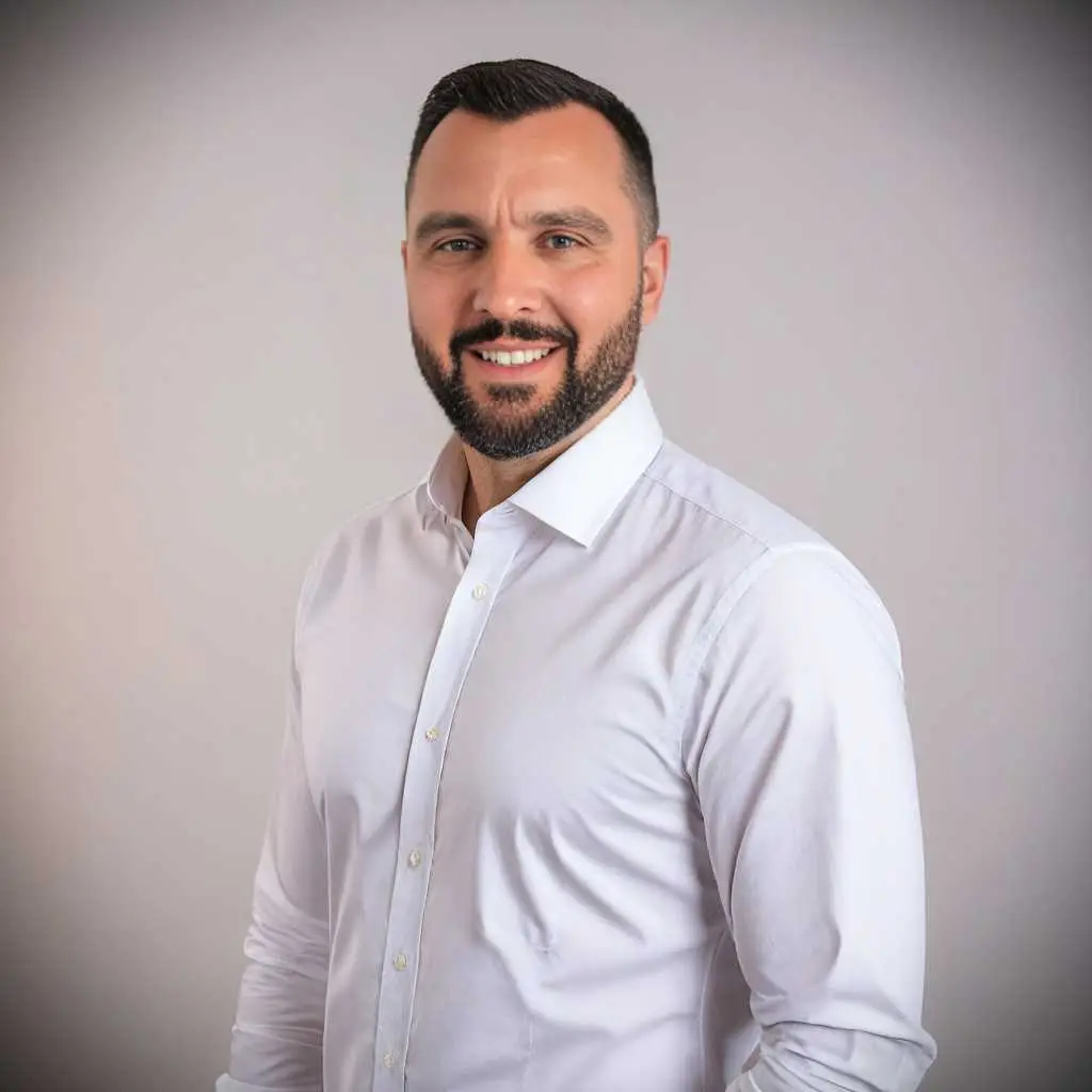 About Us 6 Professional agent with short dark hair and beard in white shirt, representing prime Ekosphere Ulcinj properties on montenegro-listings.me.
