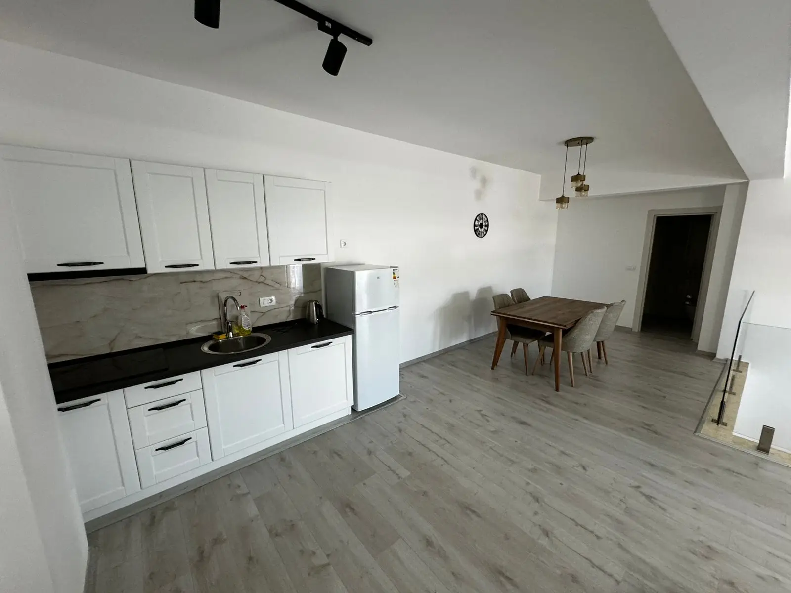 Stunning Ulcinj kitchen with sleek white cabinets, dining nook, and airy design&mdash;exclusive listing on montenegro-listings.me by Ekosphere.