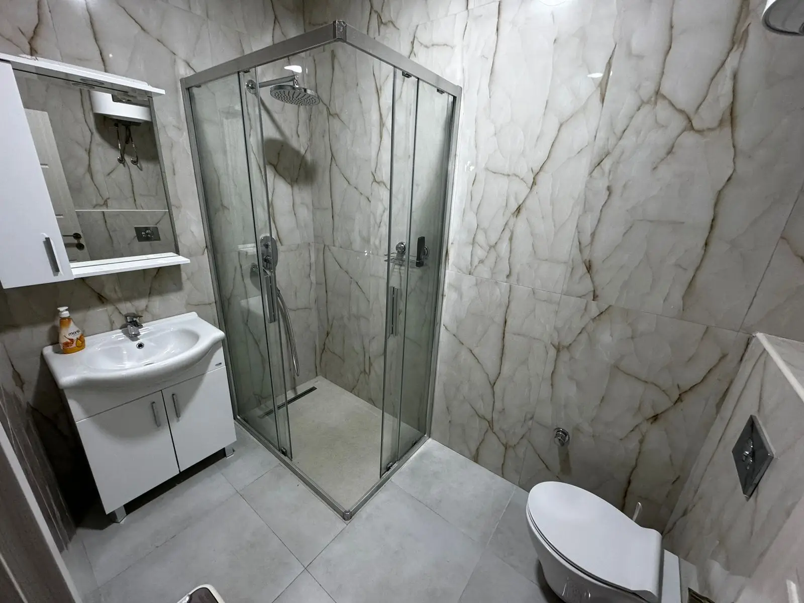 Luxurious Ulcinj property: modern bathroom with marble accents, glass shower, elegant finishes. Invest via montenegro-listings.me Ekosphere.