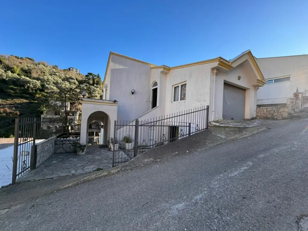 Elegant white house with yellow trim on a hill in Ulcinj, Montenegro—ideal real estate investment from ekosphere doo’s listings.