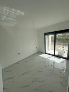 Bright, spacious room with marble tile floors and sliding glass doors—prime Ulcinj real estate by Ekosphere doo on montenegro-listings.me.