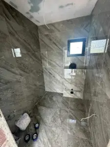 Bathroom under construction in Ulcinj with gray marble tiles—prime real estate investment via montenegro-listings.me by Ekosphere Doo.