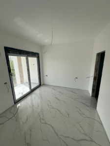 Bright, modern room in Ulcinj with marble tiles and glass doors—ideal Montenegro investment. Ekosphere doo project at montenegro-listings.me.