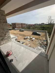 Prime investment opportunity in Ulcinj, Montenegro: balcony view of developing real estate, future homes, and growth. Powered by ekosphere doo.