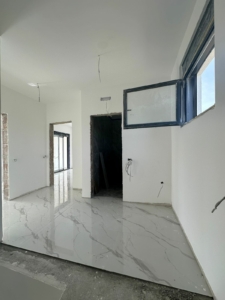 Bright, under-construction space in Ulcinj with marble tile floors—prime real estate by montenegro-listings.me, powered by Ekosphere doo.