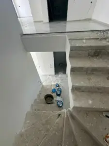Spacious unfinished interior in Ulcinj, Montenegro with concrete stairs—prime real estate investment by Ekosphere on montenegro-listings.me.