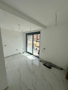 Spacious Ulcinj property: bright room with marble tile, large glass doors, ideal for investment. Listed on montenegro-listings.me by Ekosphere.