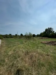 Prime Ulcinj land for sale: scenic grassy field, trees, and sky—ideal investment via montenegro-listings.me by Ekosphere doo.