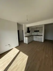 Bright, modern kitchen and living space with wood floors and built-in cabinets—ideal Ulcinj investment. Listed by ekosphere doo.