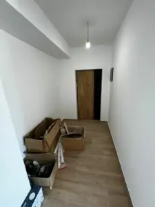Modern hallway with white walls, wood floors, overhead lighting—prime investment in Ulcinj. Exclusive at montenegro-listings.me by ekosphere doo.