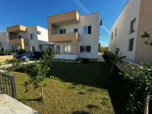 Stylish modern two-story home in Ulcinj, Montenegro with large windows, balcony & manicured lawn—listed by montenegro-listings.me.