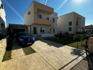 Modern two-story cream and white home in Ulcinj, Montenegro, with driveway, carport, green lawn; exclusive at montenegro-listings.me by Ekosphere doo.