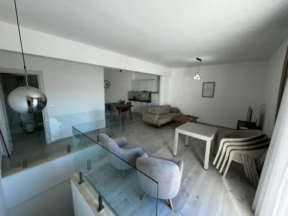 Stylish Ulcinj home: light wood floors, gray armchairs, beige sofa, glass stairway&mdash;exclusive at montenegro-listings.me by ekosphere doo.