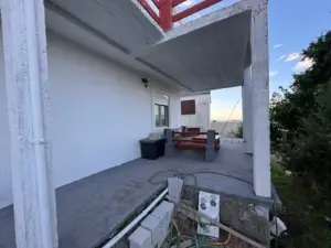 Spacious Ulcinj patio with scenic water and tree views, ideal for investing in Montenegro real estate by Ekosphere at montenegro-listings.me.