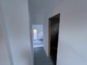 Bright hallway with sleek gray floors leads to a sunny modern room—superior Ulcinj property investment by Ekosphere, montenegro-listings.me.