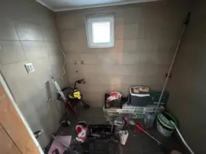 Renovation opportunity in Ulcinj, Montenegro: tiled room with window, tools; prime investment via montenegro-listings.me by Ekosphere DOO.