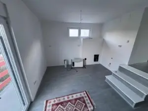 Modern unfurnished room in Ulcinj with gray floors, white walls, windows, and steps—investment property from Ekosphere doo on montenegro-listings.me.