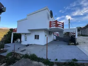 Modern white house with flat roof, red railings in Ulcinj, Montenegro—prime investment property listed on montenegro-listings.me by ekosphere doo.