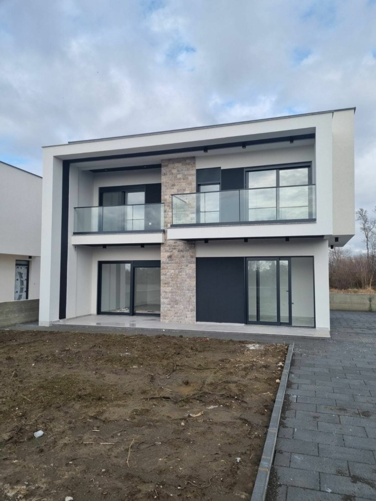 Contemporary two-story home in Ulcinj, Montenegro with glass balcony and stone features—exclusive on montenegro-listings.me by ekosphere doo.