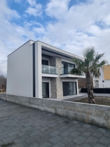 Luxury modern two-story home with glass balconies and stone accents in Ulcinj, Montenegro—prime investment via montenegro-listings.me by ekosphere doo.