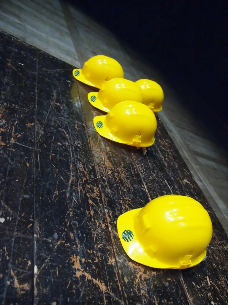 Construction supervision in Montenegro 7 Bright yellow safety helmets with blue-green stripes, symbolizing Ulcinj’s top real estate investments by Ekosphere and montenegro-listings.me.