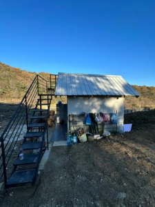 Charming Ulcinj property for sale: metal roof, outdoor staircase, lush trees—exclusive real estate at montenegro-listings.me by ekosphere doo.