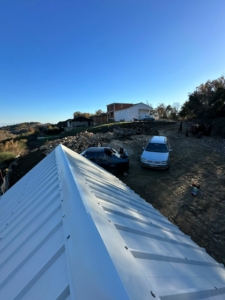 Prime Ulcinj property view: investment-ready land, parking, and nearby development under a clear sky. By Ekosphere/ montenegro-listings.me.