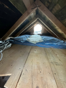 Charming attic in Ulcinj with wood floors, beams, bright window—ideal Montenegro real estate by Ekosphere doo at montenegro-listings.me.