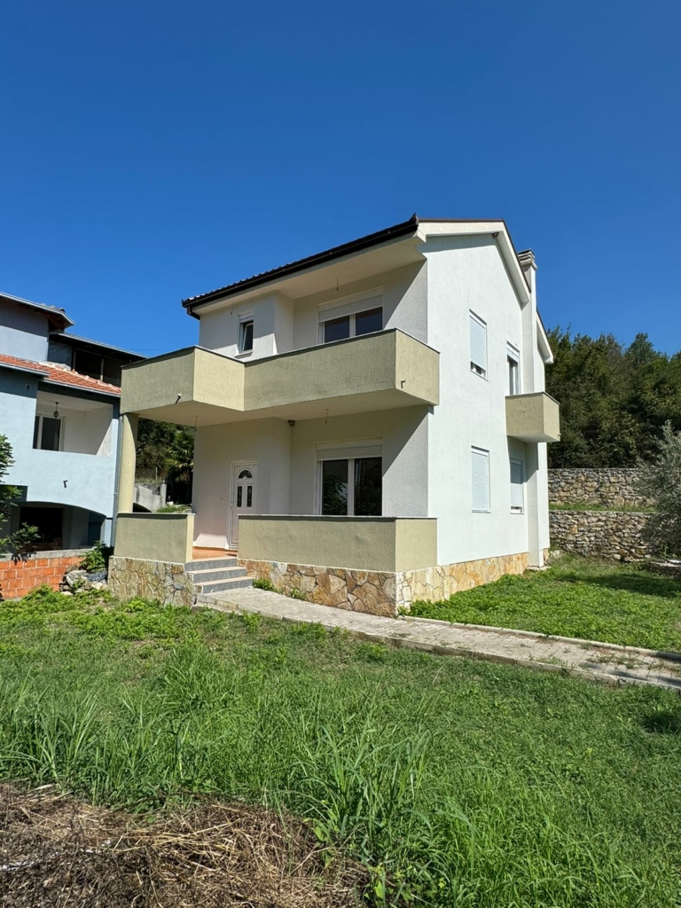 Stunning two-story white home with balconies and stone base in Ulcinj, Montenegro; ideal investment via montenegro-listings.me by ekosphere doo.