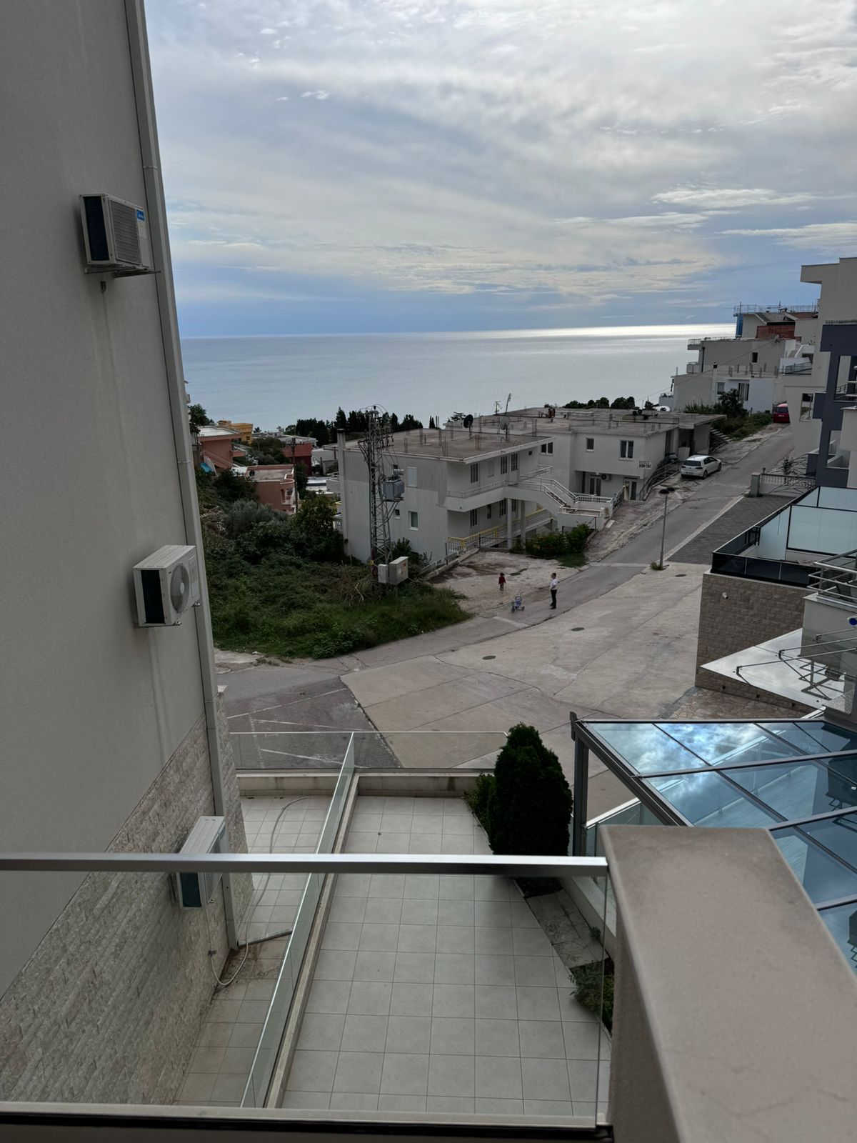 Discover premium Ulcinj real estate: balcony with sea view, lush greenery, white homes. Invest via montenegro-listings.me by Ekosphere d.o.o.