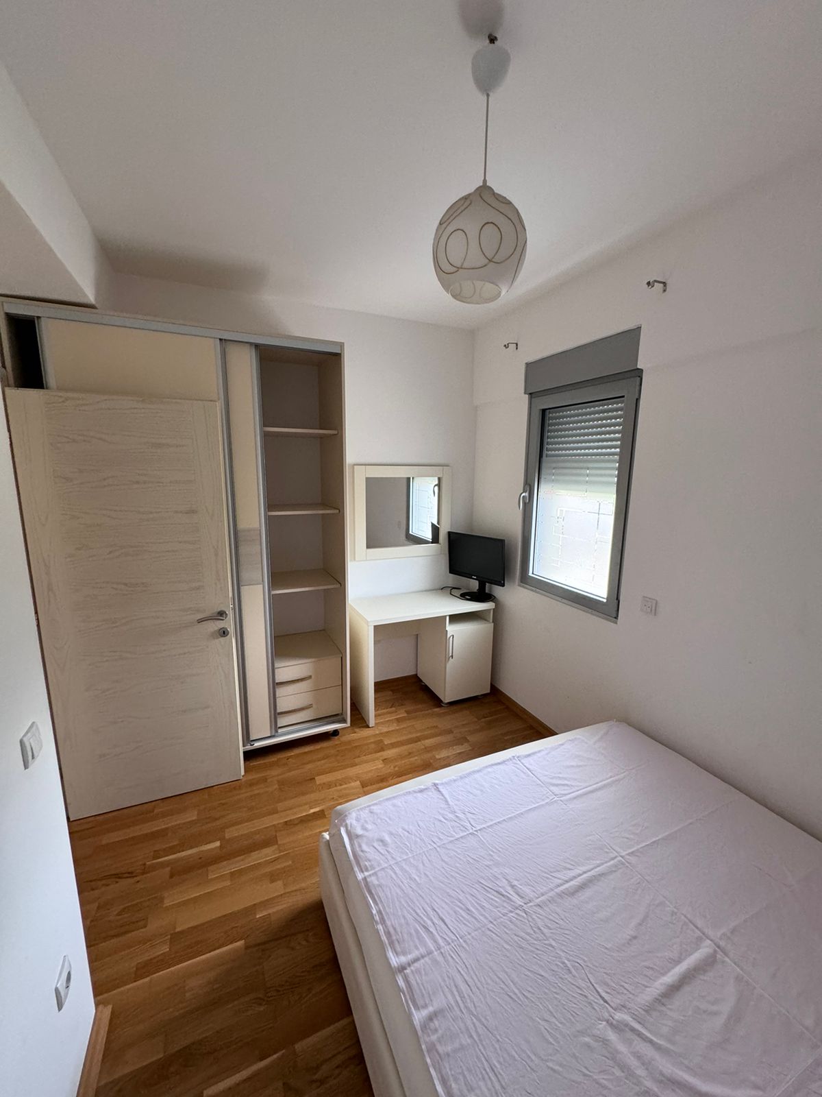 Modern Ulcinj bedroom: wooden floors, built-in closet, desk, window blinds. Prime Montenegro investment&mdash;exclusive on montenegro-listings.me by ekosphere doo.