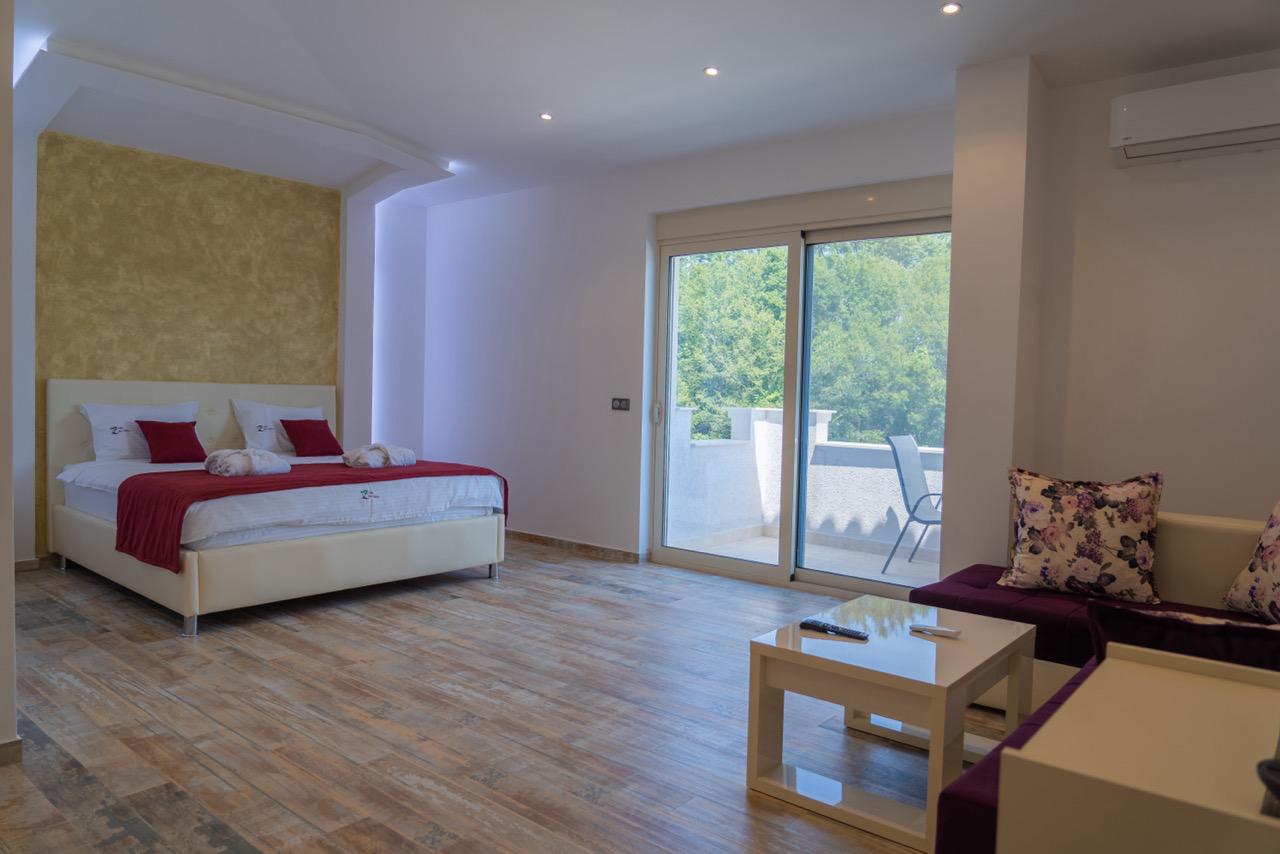 Luxurious Ulcinj hotel room with modern finishes, double bed, chic lounge, balcony&mdash;exclusive on montenegro-listings.me by ekosphere.