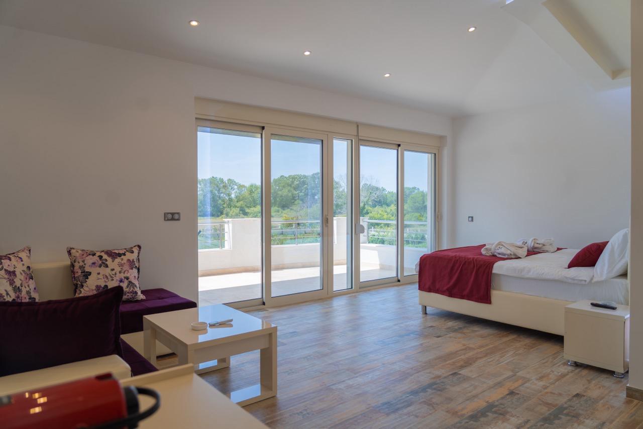 Stunning modern room in Ulcinj, Montenegro&mdash;spacious, wood floors, stylish sofa, balcony views. Exclusive on montenegro-listings.me by Ekosphere doo.