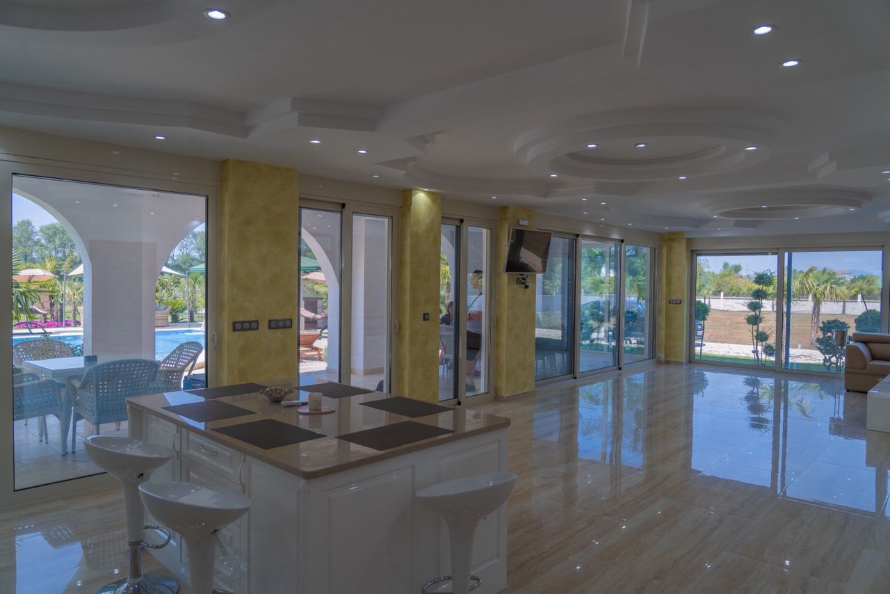 Luxury Ulcinj home with marble floors, open living space, pool view, and kitchen island&mdash;exclusive Ekosphere listing on montenegro-listings.me.