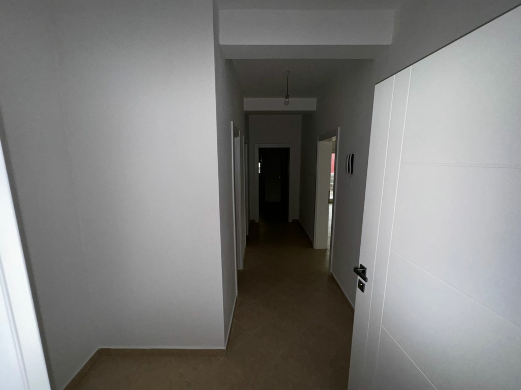 Spacious hallway with white walls, beige tile floors, and multiple doors—ideal Ulcinj property by ekosphere doo on montenegro-listings.me.
