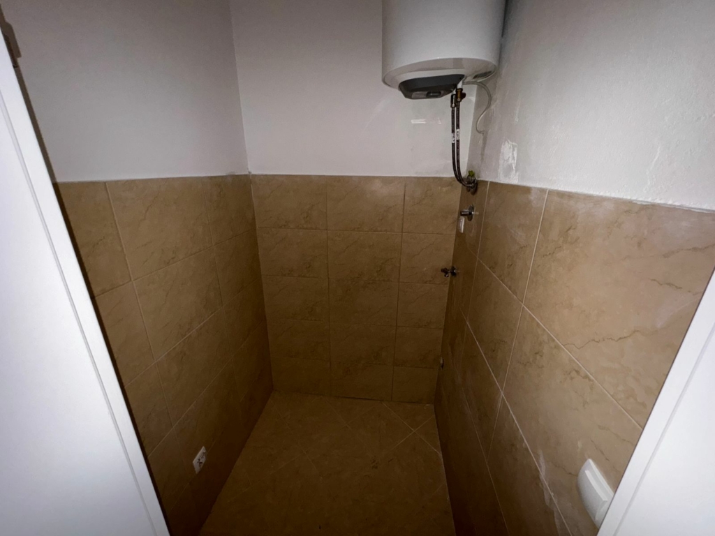 Bright, tiled utility room in Ulcinj, Montenegro with water heater—ideal investment, eco-friendly; on montenegro-listings.me by ekosphere doo.