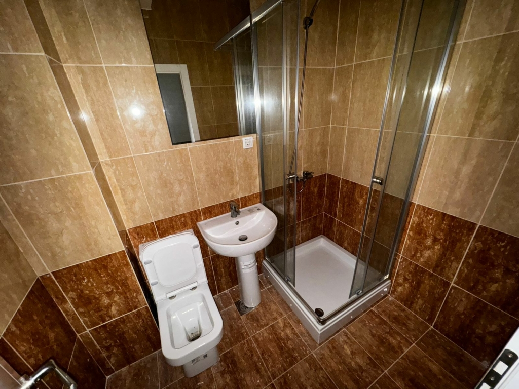 Modern Ulcinj bathroom with stylish tiles, glass shower, and quality fixtures. Exclusive at montenegro-listings.me by ekosphere doo.