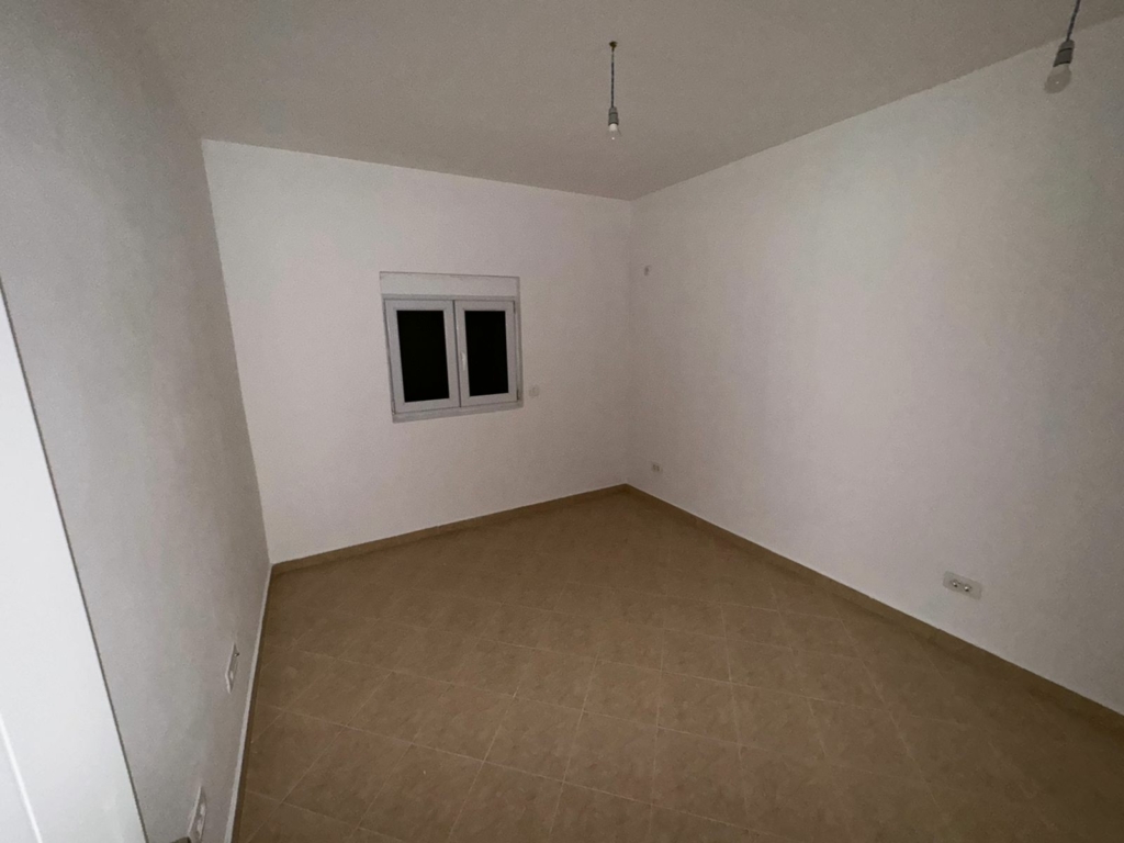 Bright, spacious room in Ulcinj, Montenegro with tiled floor, white walls, double window—prime investment at montenegro-listings.me by ekosphere doo.