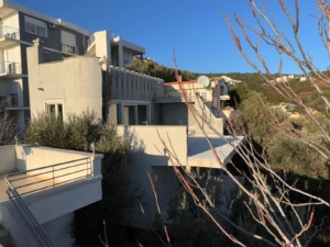 Luxury multi-story grey and white building with balconies in Ulcinj, Montenegro—prime real estate by montenegro-listings.me.