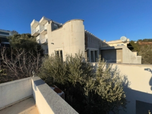 Contemporary light-grey building with balconies and large windows in Ulcinj, Montenegro—prime real estate by montenegro-listings.me.