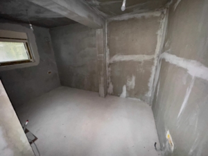 Unfinished room with concrete walls, small window—prime Ulcinj investment on montenegro-listings.me by Ekosphere doo.