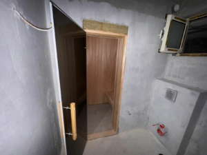 Investment opportunity in Ulcinj: unfinished space with concrete walls, exposed wires, wooden sauna; list on montenegro-listings.me by Ekosphere.