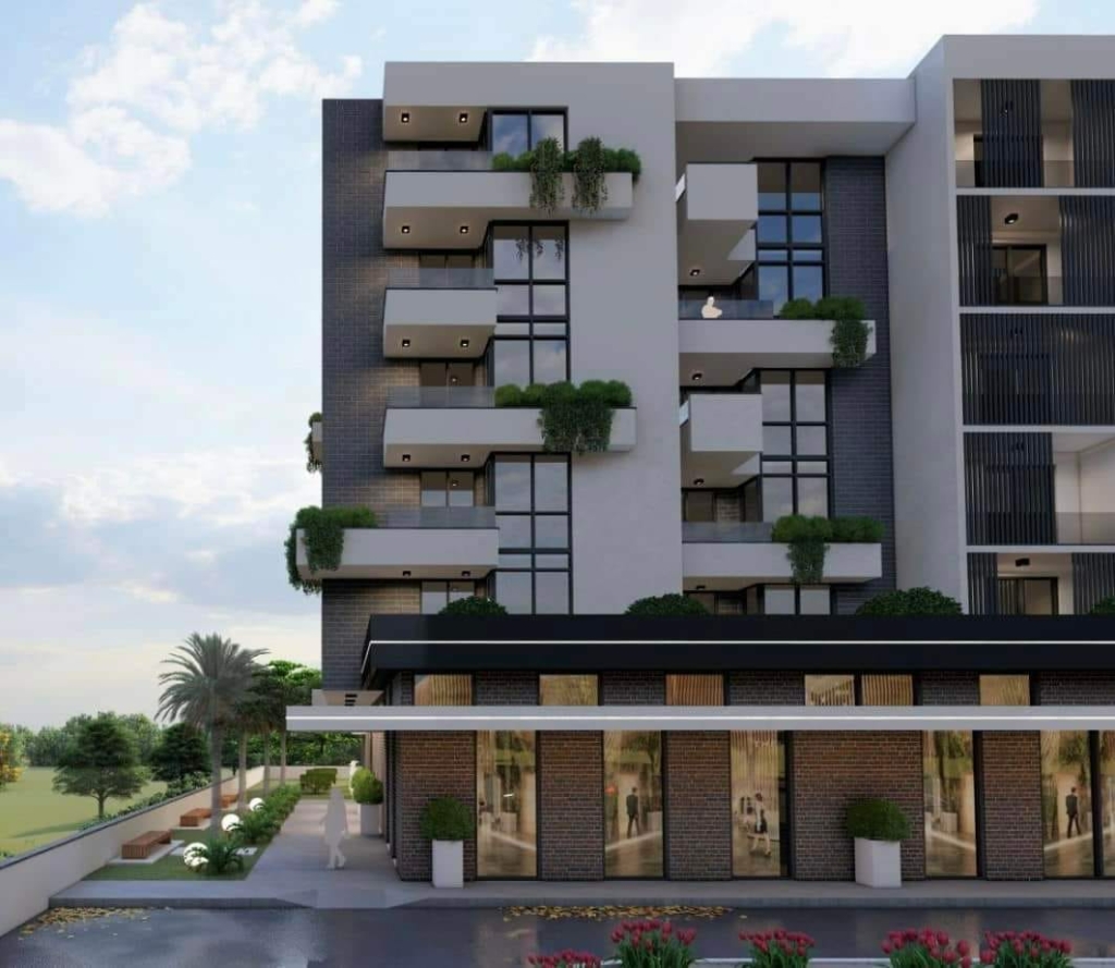 Contemporary multi-story building in Ulcinj with glass balconies, large windows, and premium storefronts—invest with ekosphere doo.