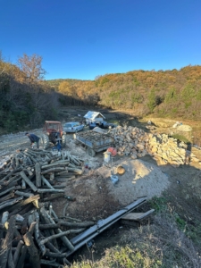 Prime eco-investment land in Ulcinj: spacious, tree-lined plot with work crews, logs, stones, and vehicles—exclusively at montenegro-listings.me by ekosphere doo.