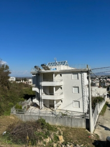 Modern white three-story property with balconies, roof terrace, and fenced lot in Ulcinj—premium investment via montenegro-listings.me.