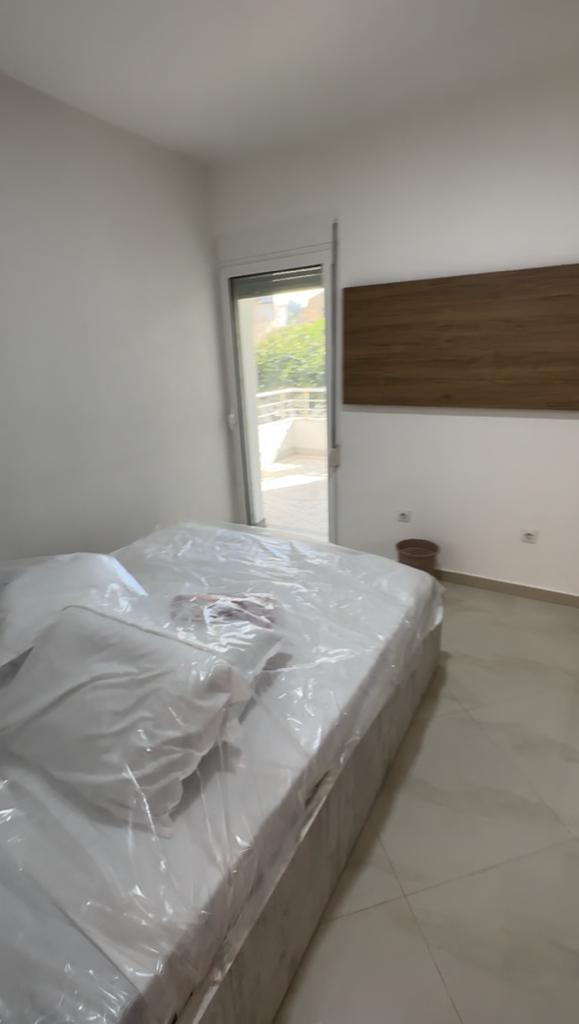 Modern Ulcinj bedroom with balcony access, double bed, tiled floor&mdash;prime Montenegro real estate by montenegro-listings.me/Ekosphere.