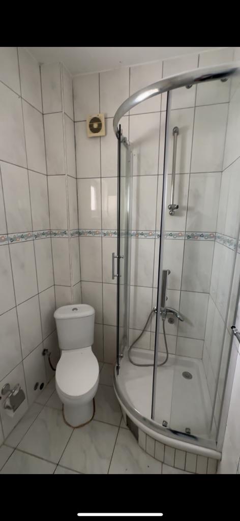 Modern, eco-friendly bathroom in Ulcinj property: white tiles, stylish shower, quality fittings. Ekosphere doo at montenegro-listings.me.
