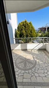 Stunning glass door view to a tiled balcony in Ulcinj, Montenegro—prime property by Ekosphere doo on montenegro-listings.me.