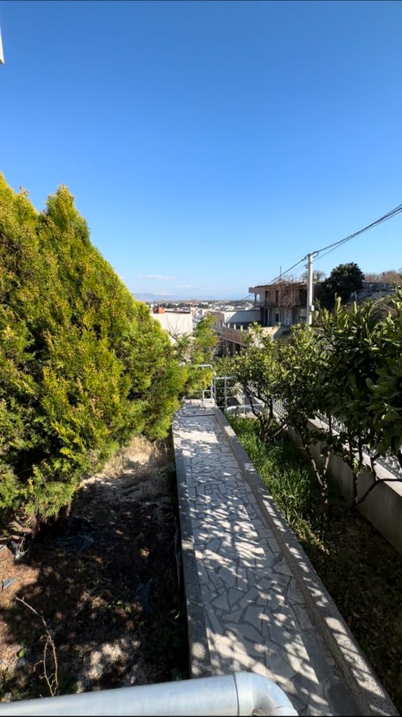 Scenic tiled path curves through lush greenery toward prime Ulcinj properties&mdash;exclusive on montenegro-listings.me by ekosphere doo.