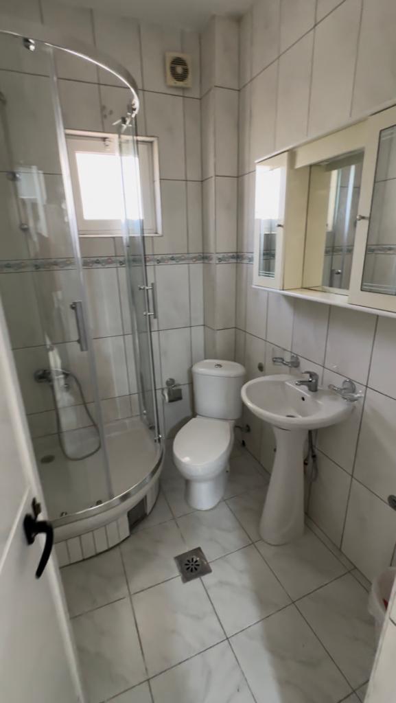 Modern bathroom with white tiles, glass shower, sleek fixtures&mdash;perfect Ulcinj investment. Exclusive at montenegro-listings.me by ekosphere doo.